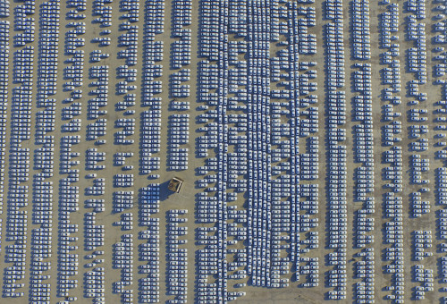 An aerial view shows new Audi cars in an open-air parking lot in Changchun